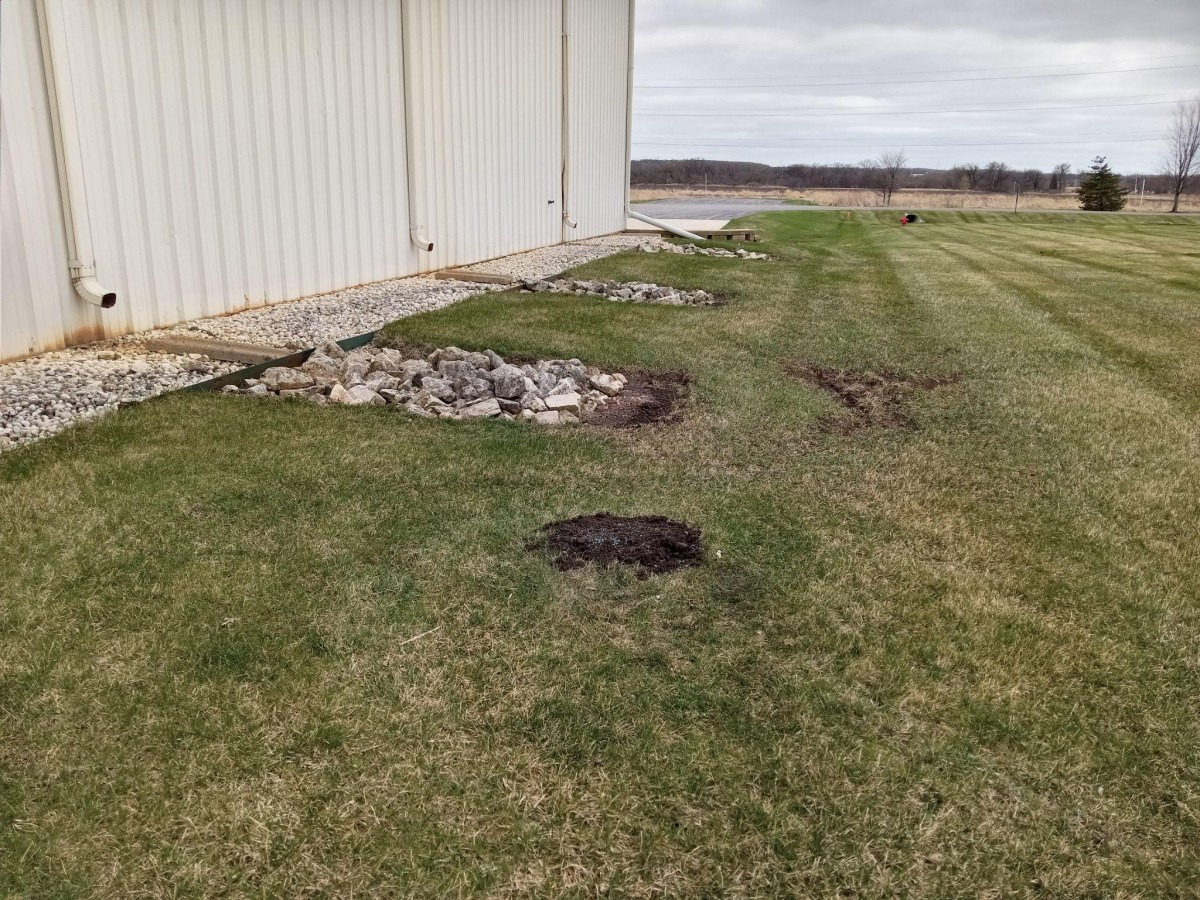 Orphaned wells marked by dark soil